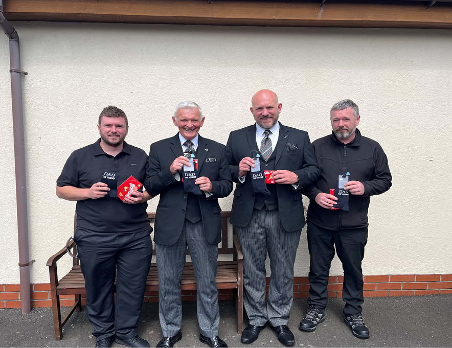The 4 fathers who work at M L Williams holding their gifts.